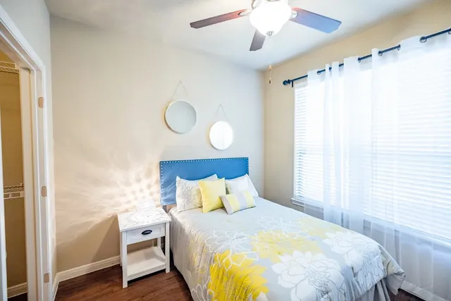 a bedroom with a bed and wooden floor
