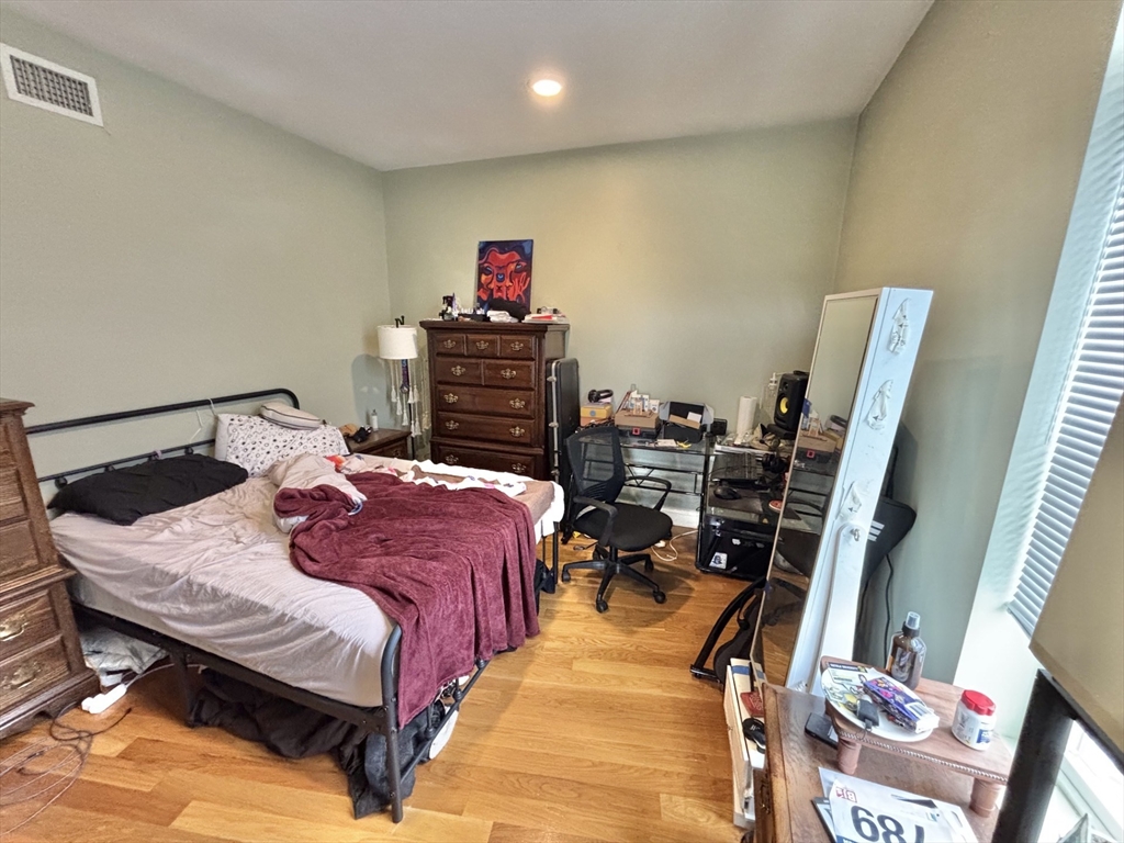 10 Roxbury Street, Unit 10 Boston, MA 02119 - Photo 6 of 8 a bed sitting in a bedroom next to a window