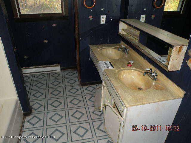 2136 Ross Road Dalton, PA 18414 - Photo 6 of 9 a bathroom with a sink toilet and mirror