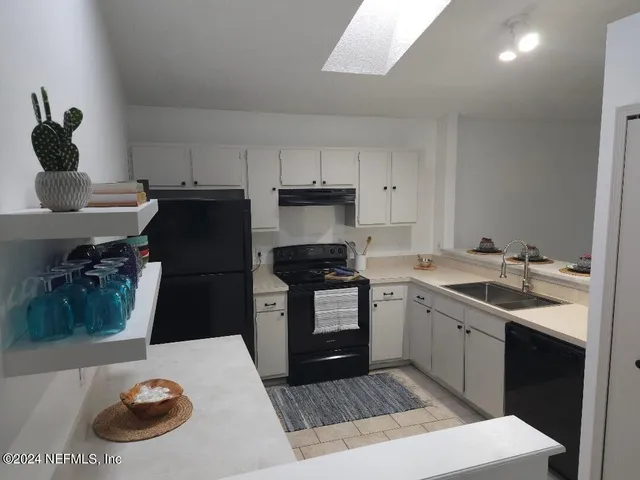 a kitchen with a sink a stove and refrigerator