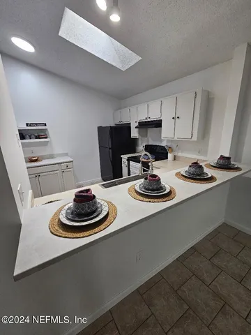 a kitchen with a stove and cabinets