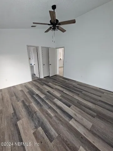 a bedroom with a bed and a ceiling fan