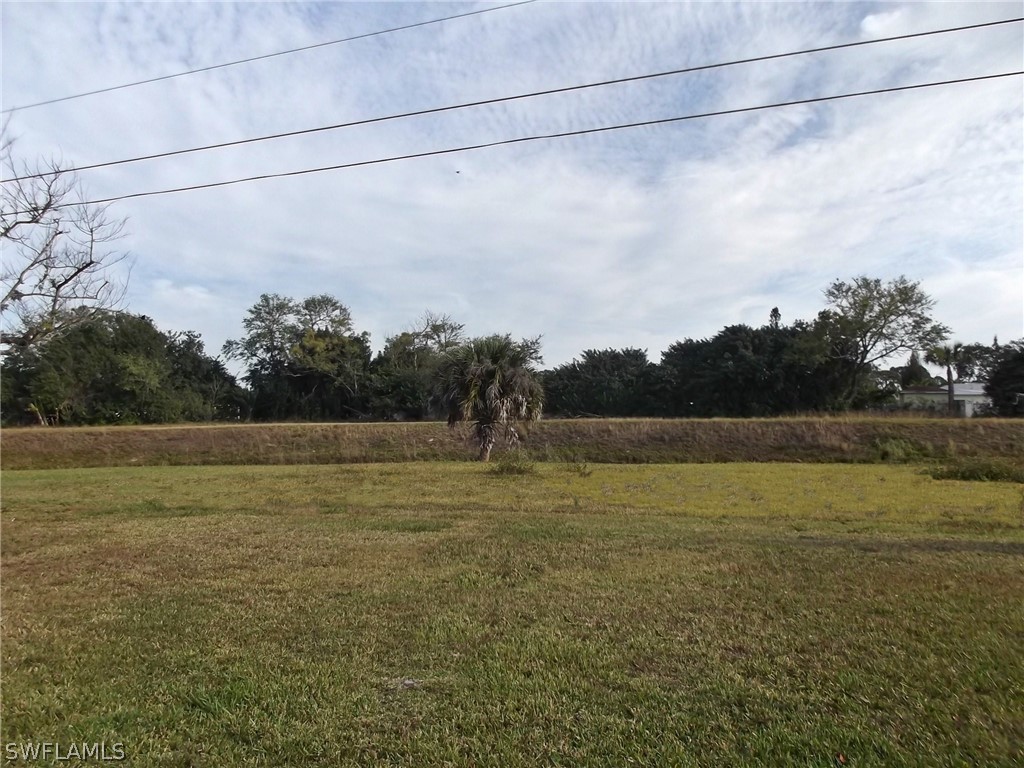 203 Davis Road Lehigh Acres, FL 33936 - Photo 2 of 10 a view of an outdoor space and a yard