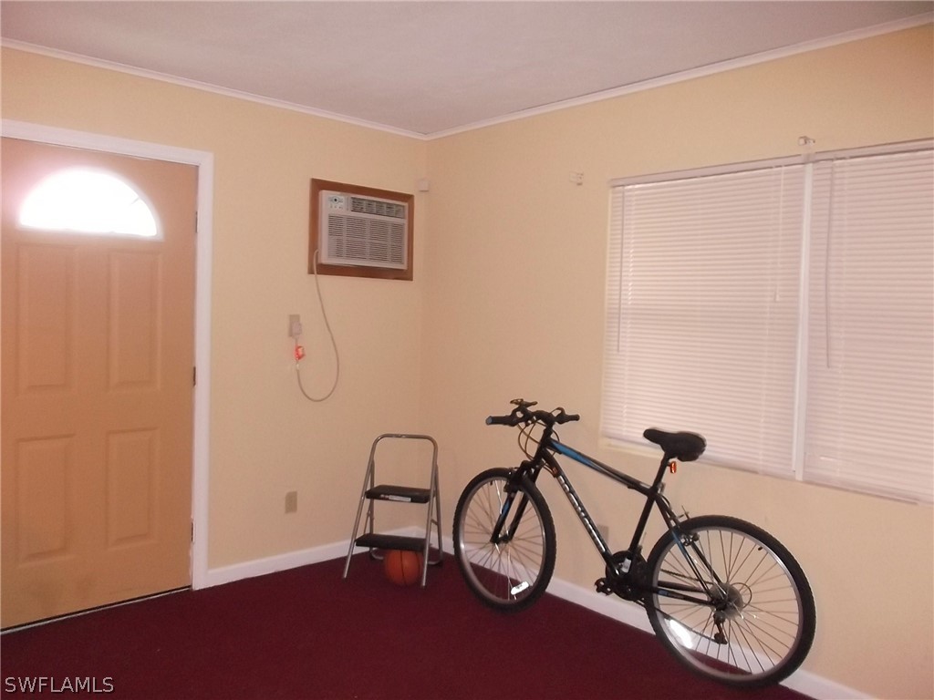 203 Davis Road Lehigh Acres, FL 33936 - Photo 6 of 10 a view of a room with gym equipment