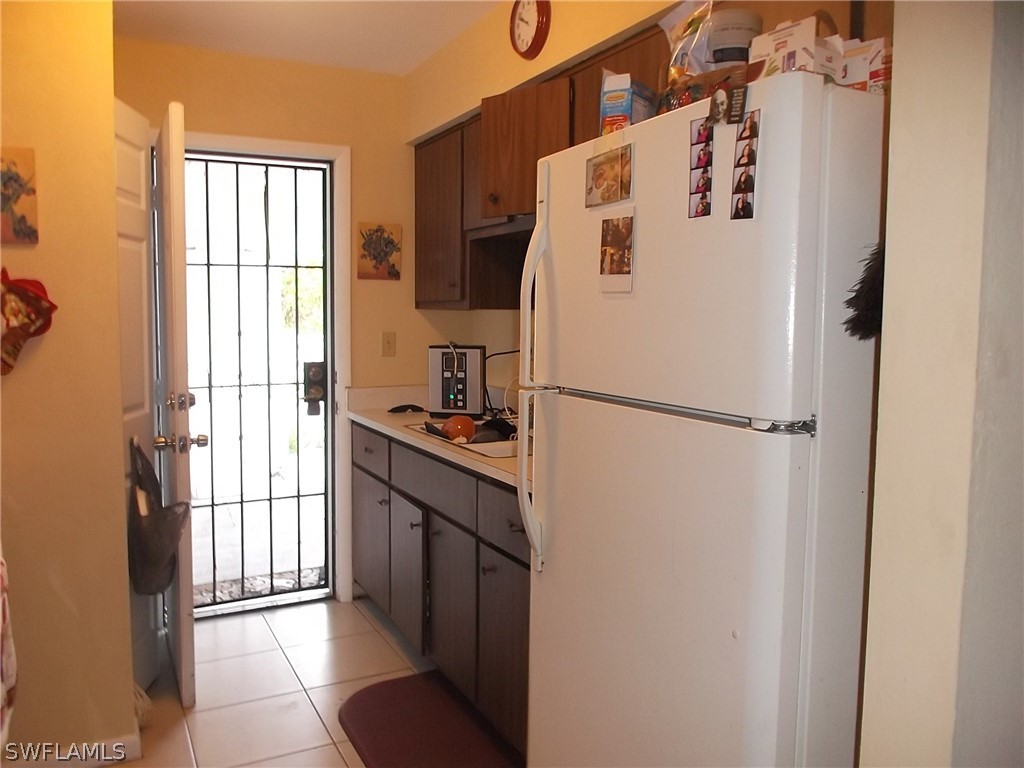 203 Davis Road Lehigh Acres, FL 33936 - Photo 7 of 10 a white refrigerator freezer and a dishwasher in a kitchen