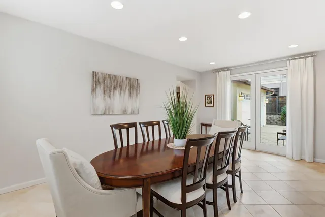 a view of a dining room with furniture and a potted plant