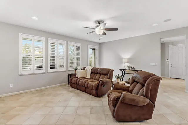 a living room with furniture and kitchen view