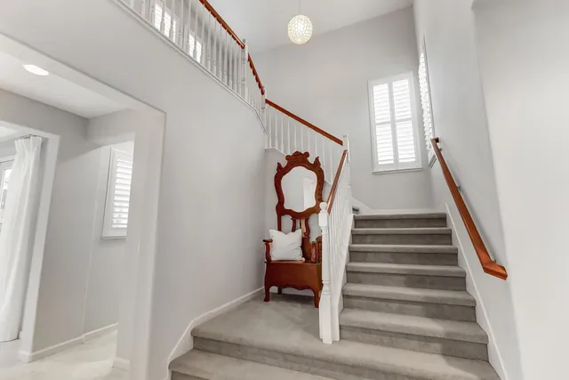 a spacious bathroom with a double vanity sink large mirror and a bathtub