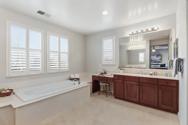 a bedroom with a bed chair and a window