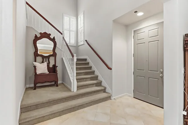 a living room with furniture a fireplace and a large window