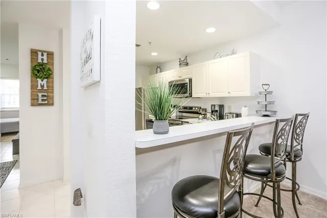 a kitchen with stainless steel appliances a sink and a refrigerator