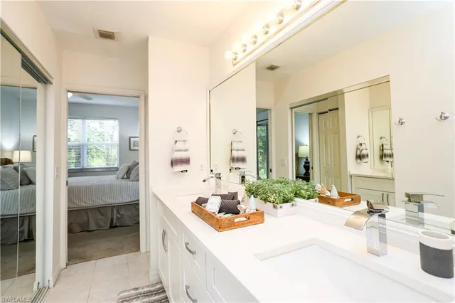 a bathroom with a tub sink and mirror