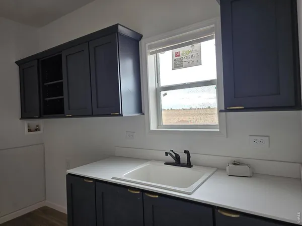 a kitchen with a sink cabinets and a window
