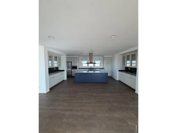 a living room with furniture and kitchen