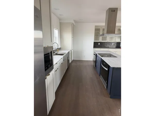 a kitchen with granite countertop a sink and a stove