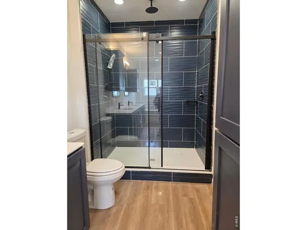 a bathroom with a toilet and a shower