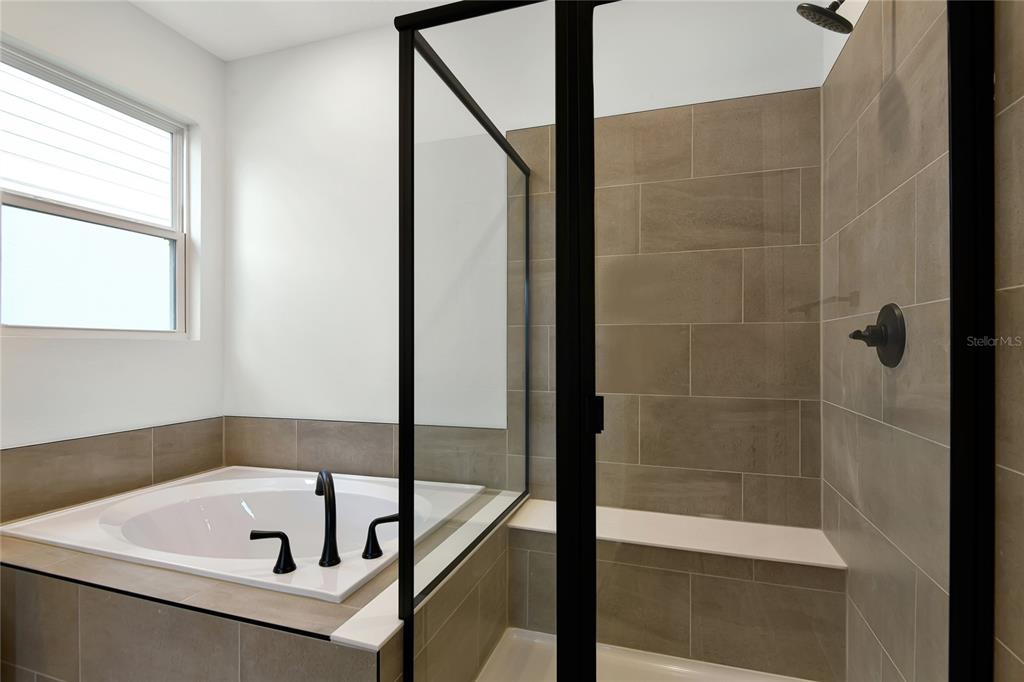 145 Waterstone Loop Tavares, FL 32778 - Photo 12 of 16 a bathroom with a tub and shower