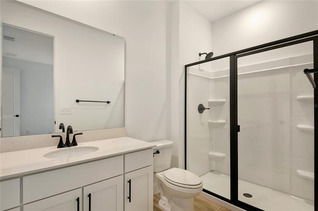 145 Waterstone Loop Tavares, FL 32778 - Photo 14 of 16 a bathroom with a sink toilet and shower