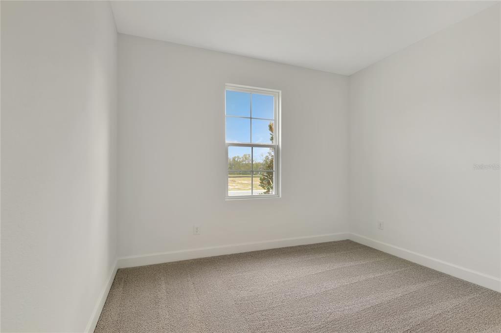 145 Waterstone Loop Tavares, FL 32778 - Photo 3 of 16 a view of an empty room with a window