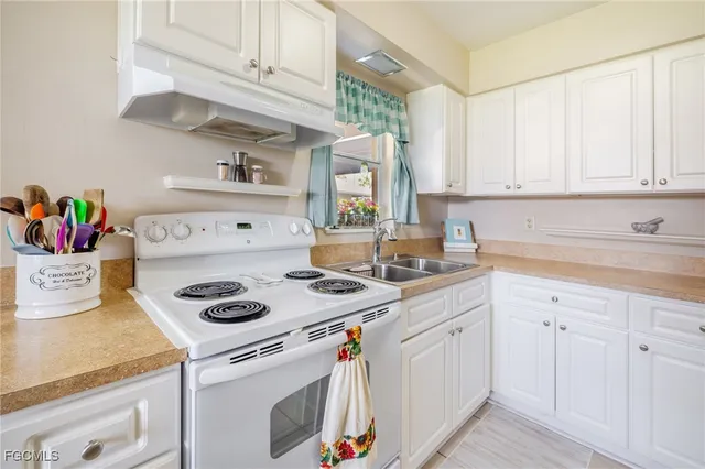 a kitchen with stainless steel appliances granite countertop a sink and dishwasher a stove with wooden floor