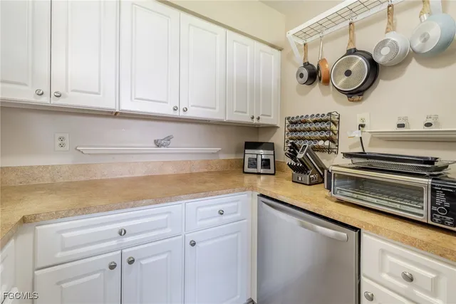 a kitchen with kitchen island a sink stove and white cabinets