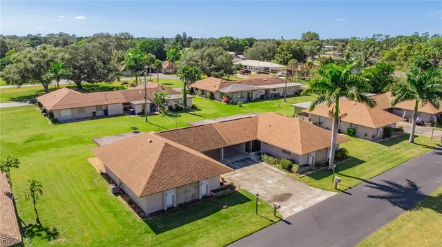 an aerial view of multiple houses with yard