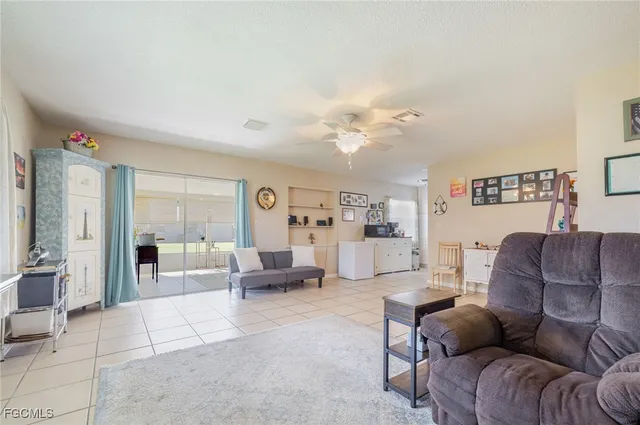 a living room with furniture and white walls