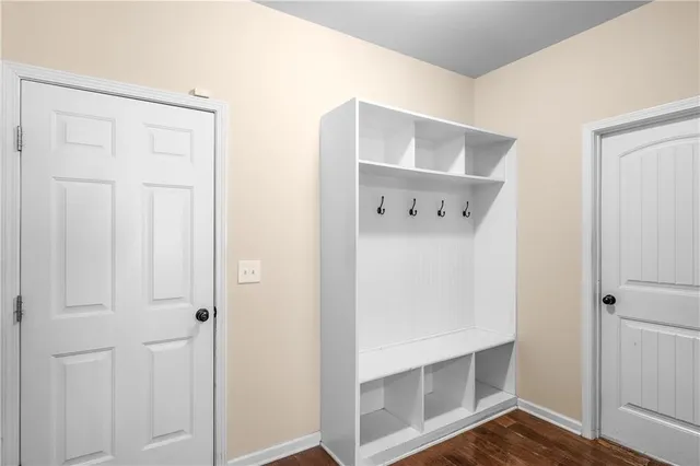 a view of a hallway with wooden floor and entryway