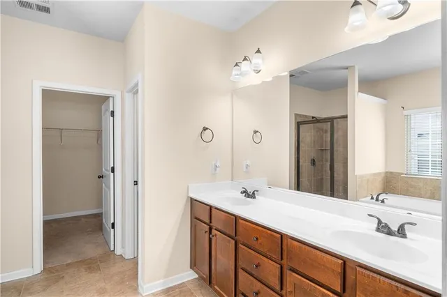 a bathroom with a double vanity sink mirror and