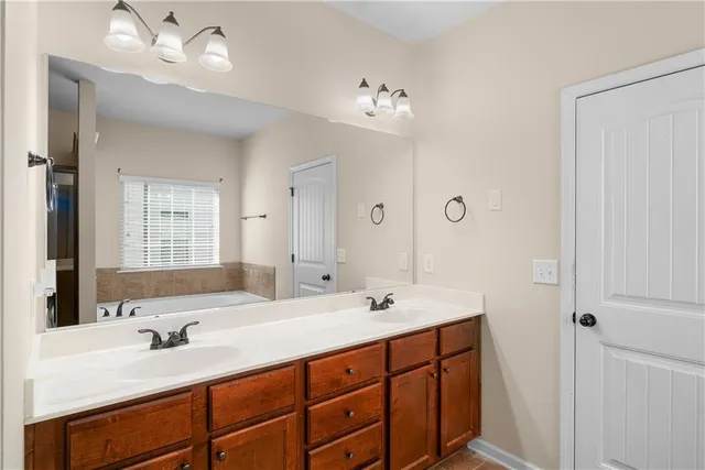 a bathroom with double vanity sinks and a mirror
