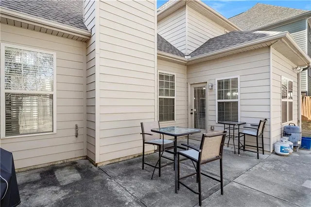 a view of a house with backyard and sitting area