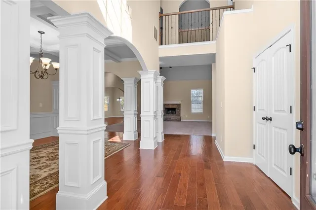 a view of a hallway with wooden floor and staircase