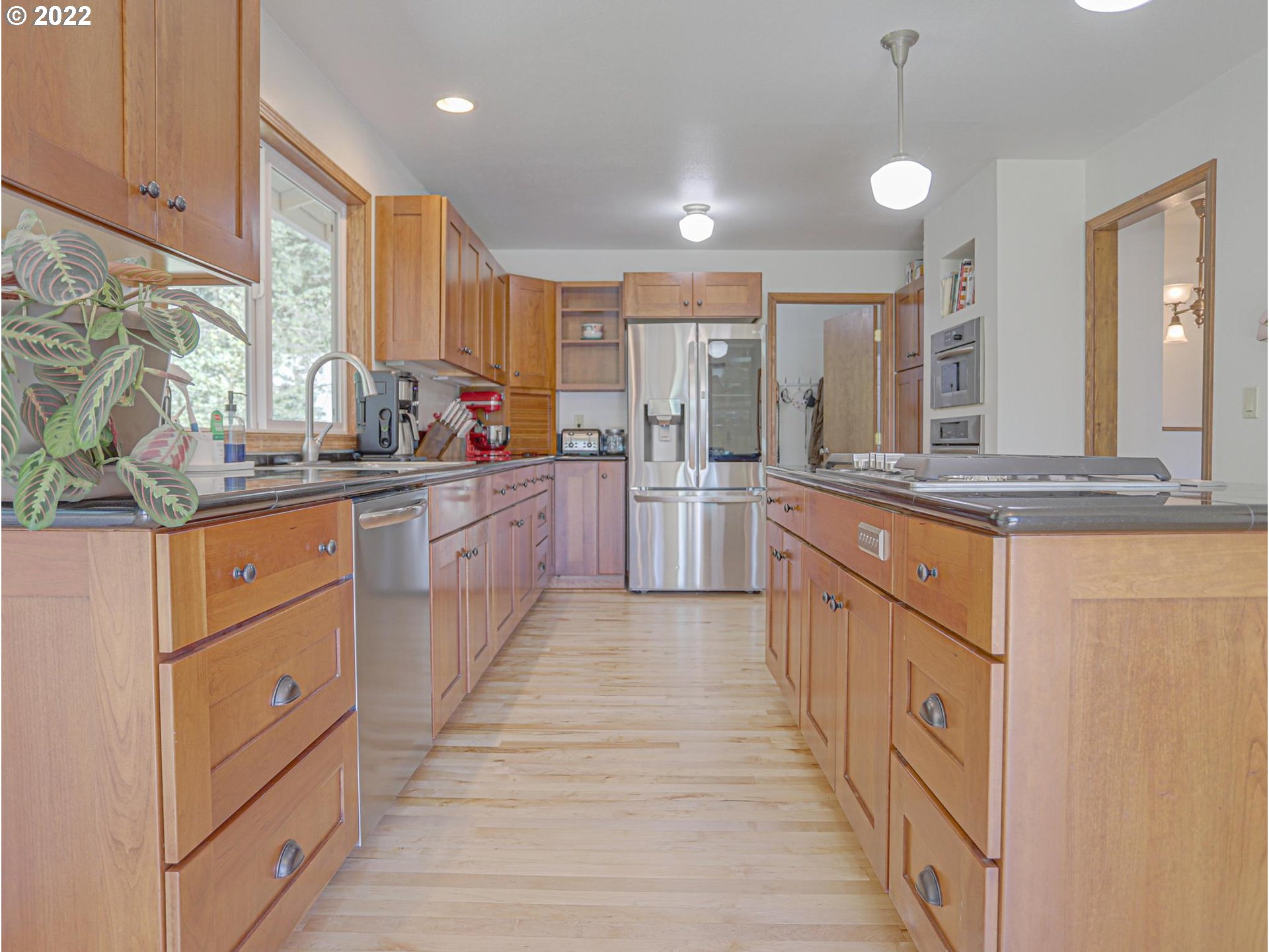 43370 Southeast Pagh Road Sandy, OR 97055 - Photo 5 of 29 a large kitchen with stainless steel appliances kitchen island granite countertop a sink and cabinets