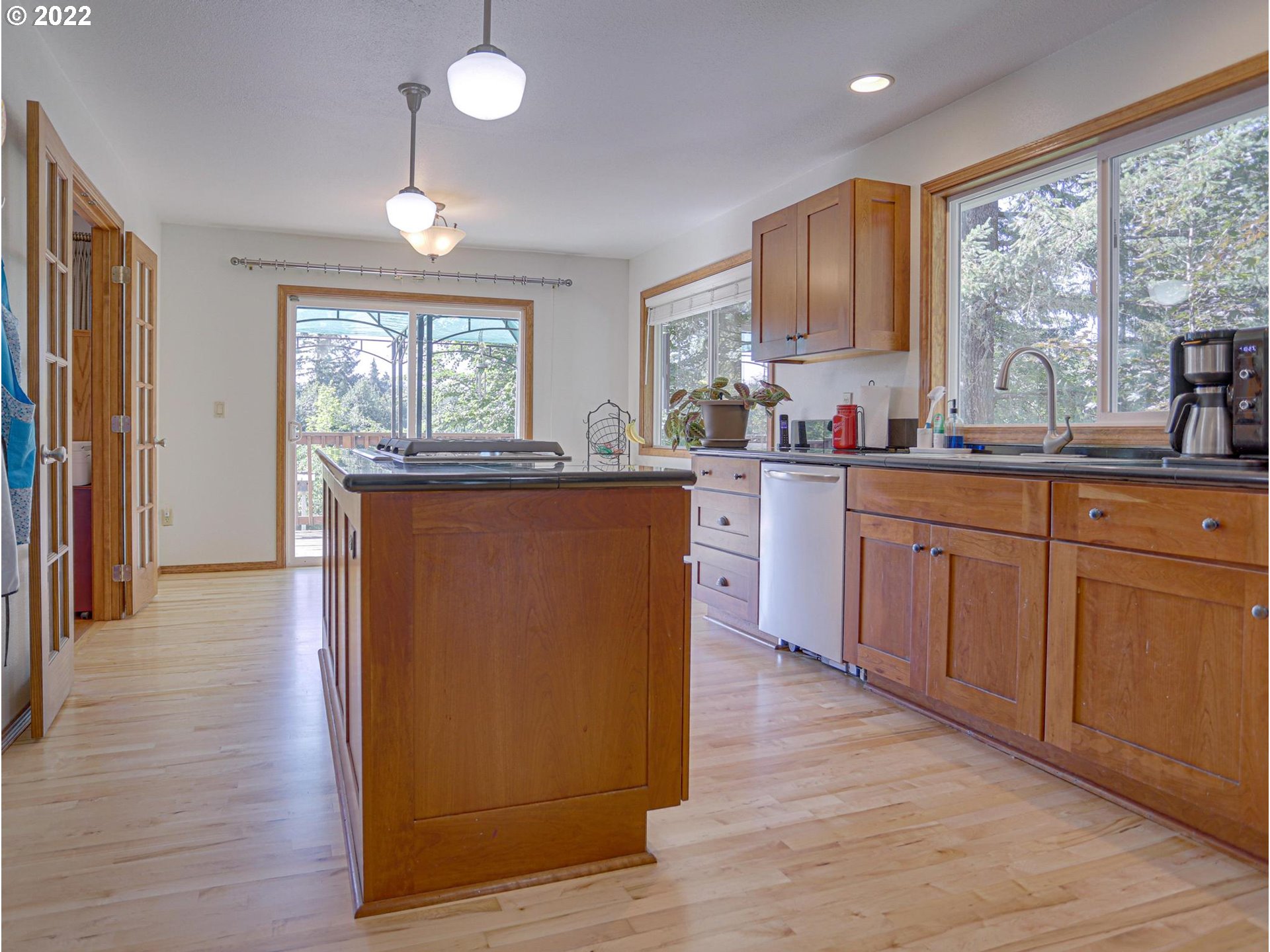 43370 Southeast Pagh Road Sandy, OR 97055 - Photo 7 of 29 a kitchen with wooden floors and wooden cabinets
