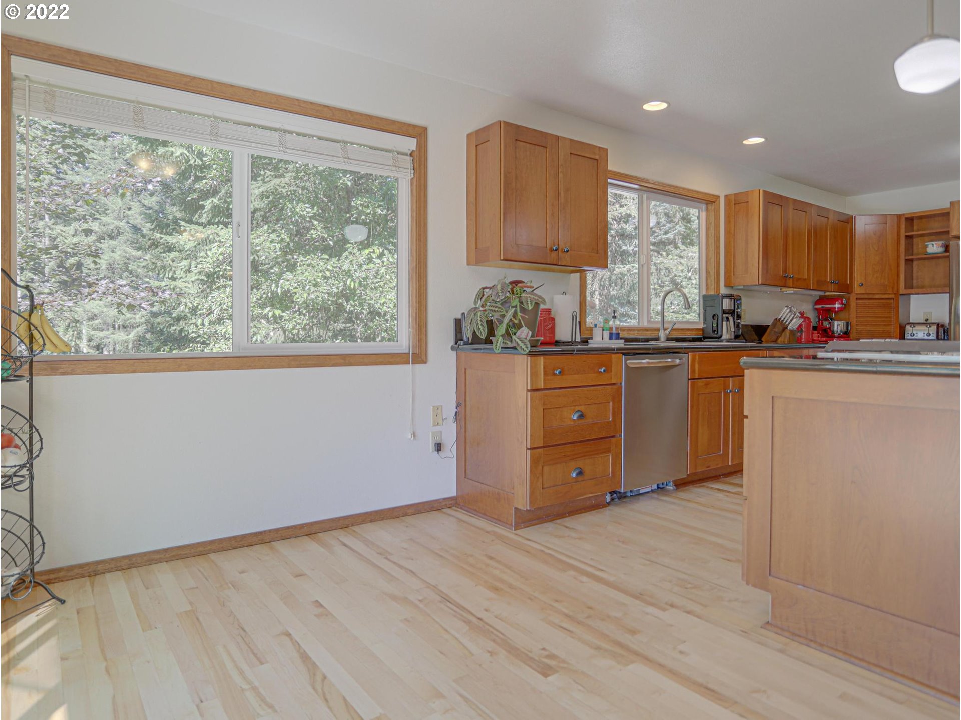 43370 Southeast Pagh Road Sandy, OR 97055 - Photo 8 of 29 a kitchen with stainless steel appliances granite countertop a stove a sink dishwasher and a refrigerator with wooden floor