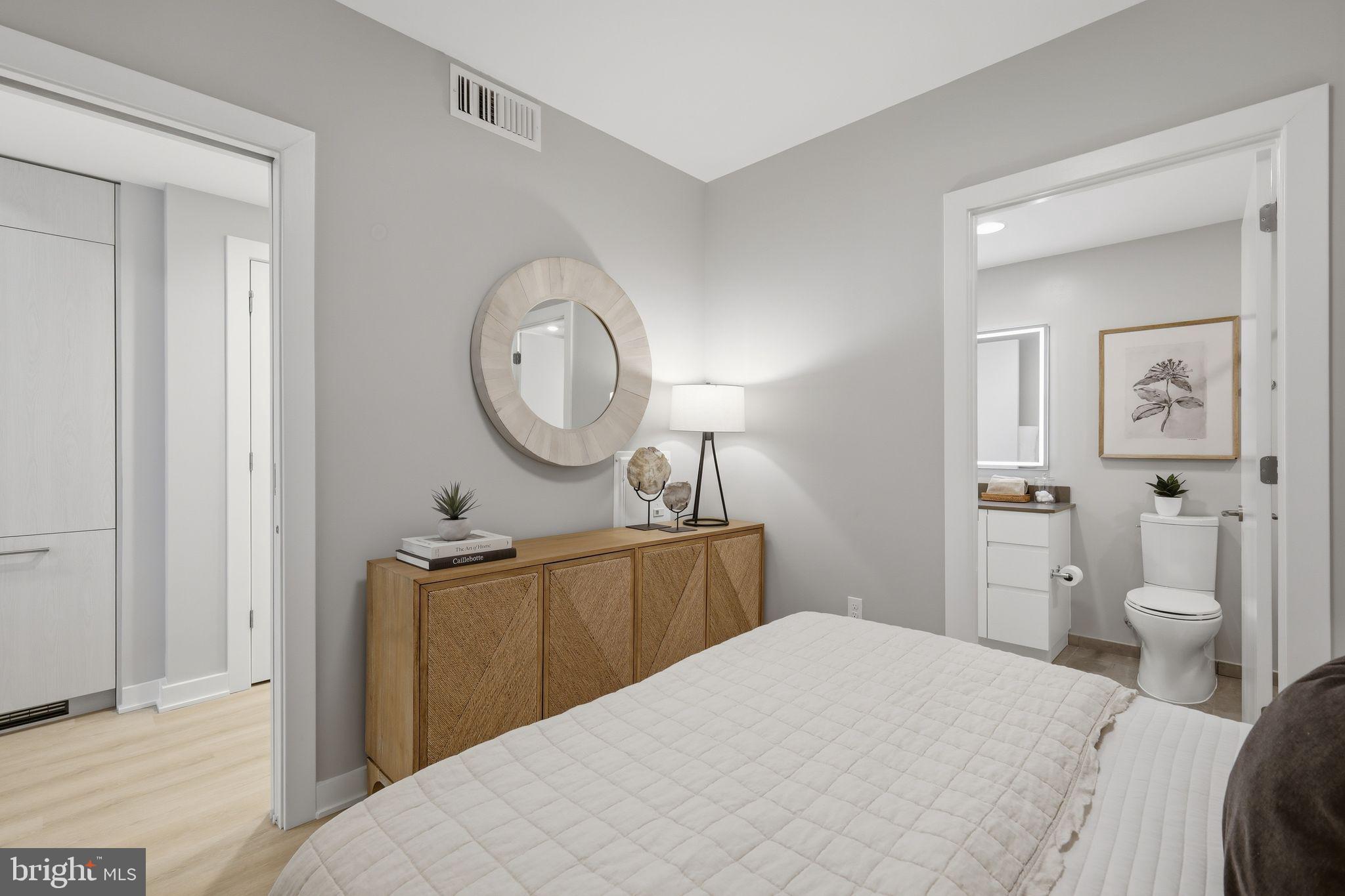 950 3rd Street Northwest, Unit 1009 Washington, DC 20001 - Photo 31 of 32 a bedroom with a bed and a chandelier
