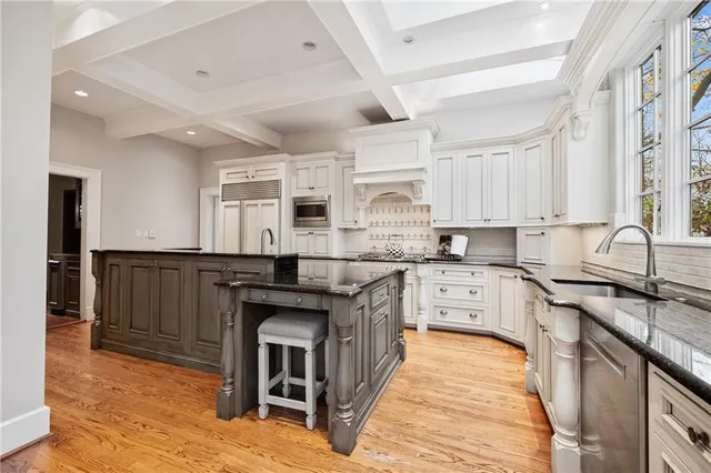 a kitchen with granite countertop a sink and chairs
