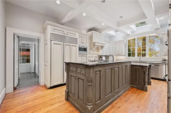 a kitchen with granite countertop white cabinets and appliances