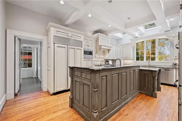 a kitchen with granite countertop white cabinets and appliances