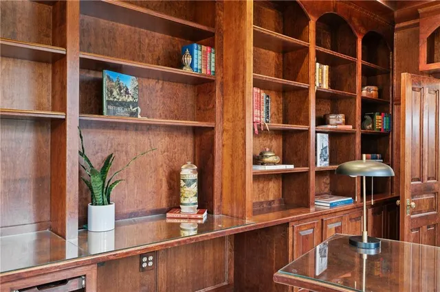 a kitchen with stainless steel appliances cabinets and a large window