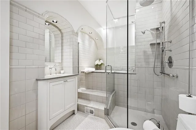 a spacious bedroom with a bed and a chandelier