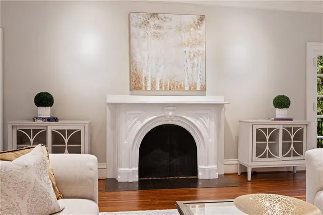 a living room with furniture a rug and a window