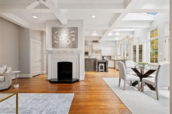 a living room with furniture a fireplace and a table