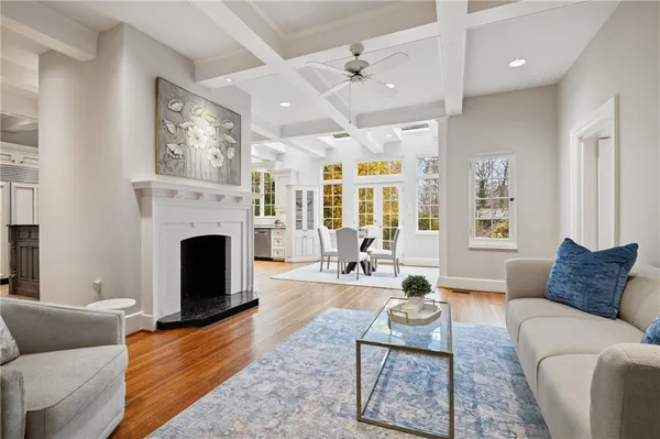 a living room with furniture a fireplace and a large window