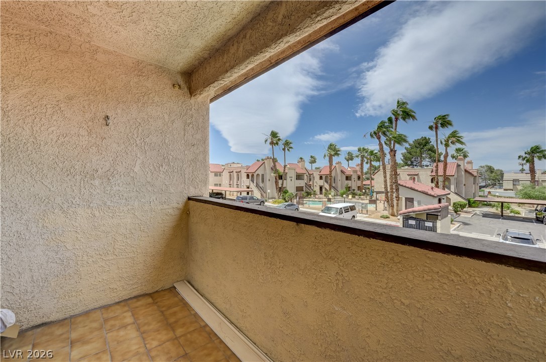 1751 East Reno Avenue, Unit 228 Las Vegas, NV 89119 - Photo 31 of 39 Enjoy views of the community pool and palm trees from this private balcony.