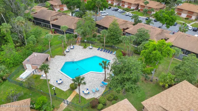 an aerial view of a house with table and chairs and a fire pit