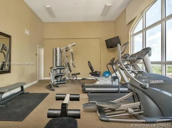 a room with gym equipment and a large window