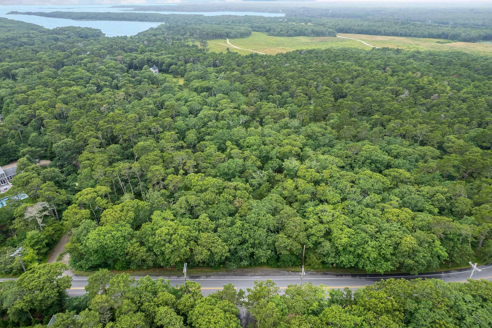 8 Meshacket Wood Road Edgartown, MA 02539 - Photo 2 of 7 a view of a field with an outdoor space