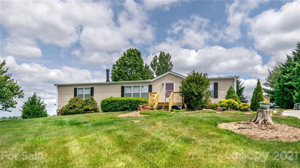 449 Divide Loop Flat Rock, NC 28731 - Photo 2 of 36 a front view of a house with garden