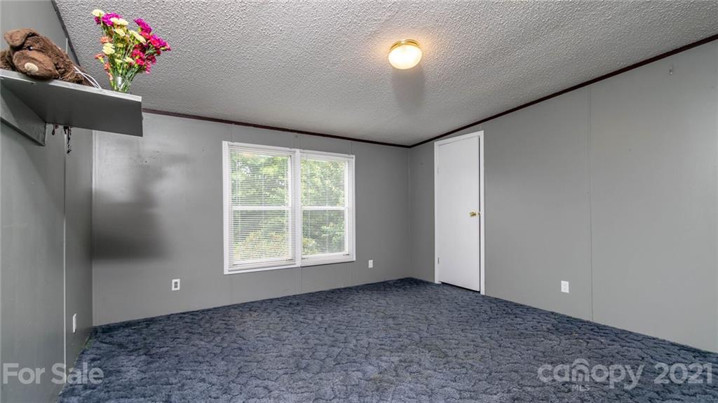 449 Divide Loop Flat Rock, NC 28731 - Photo 26 of 36 a view of an empty room with a window and toys